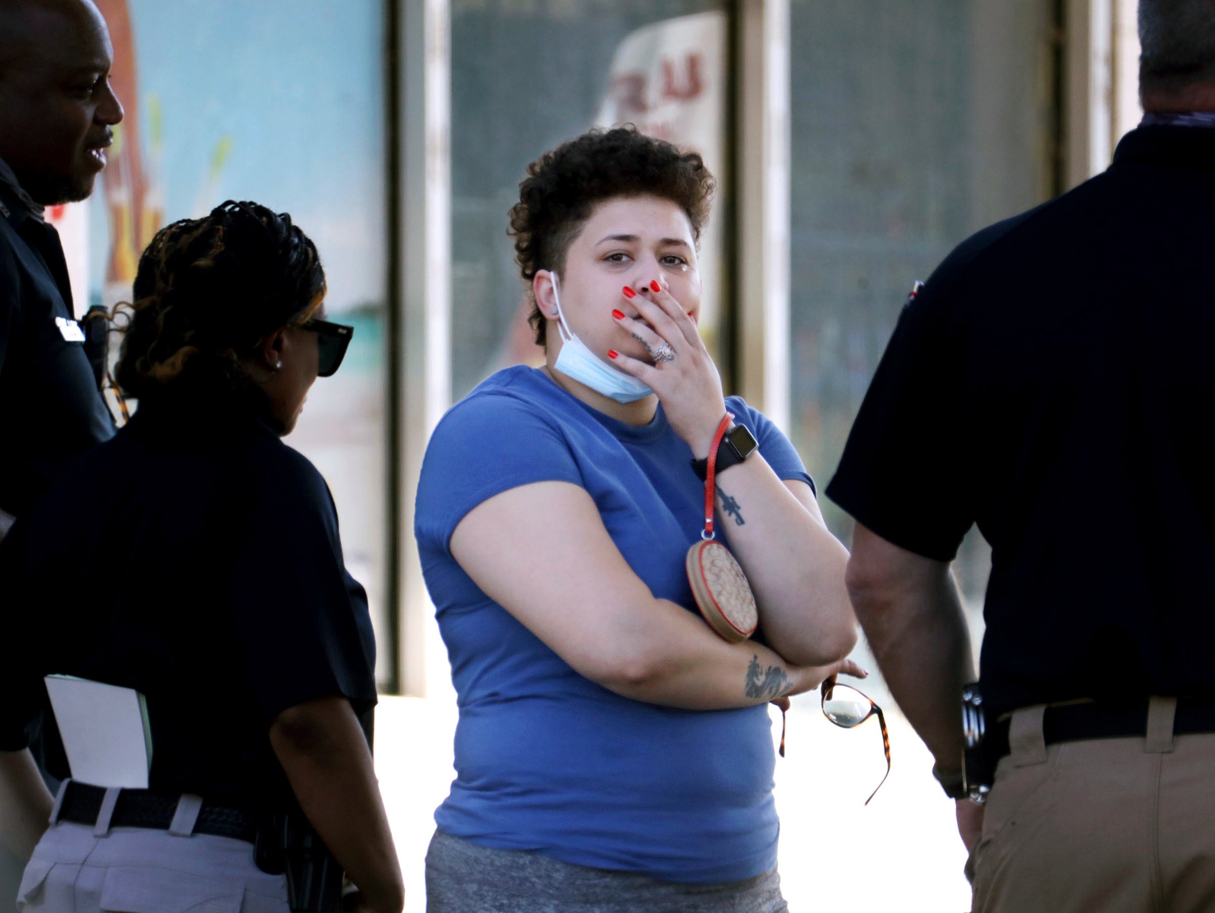Family members of victims wait with Memphis Police Department officers outside of a post office after a shooting