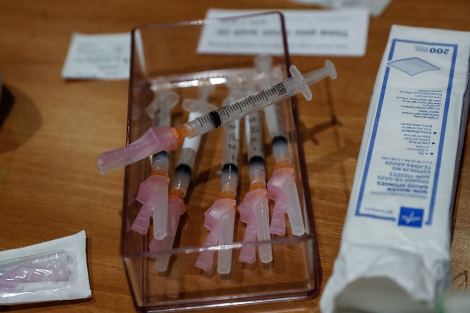 Syringes filled with a dose of the Moderna Covid-19 vaccine sit on a table during an employee vaccination at the Sarasota Memorial Hospital in Sarasota, Florida, US.