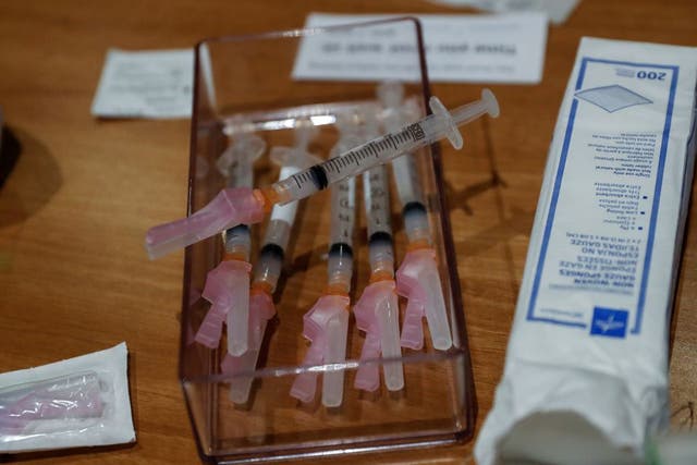 <p>Syringes filled with a dose of the Moderna Covid-19 vaccine sit on a table during an employee vaccination at the Sarasota Memorial Hospital in Sarasota, Florida, US. </p>