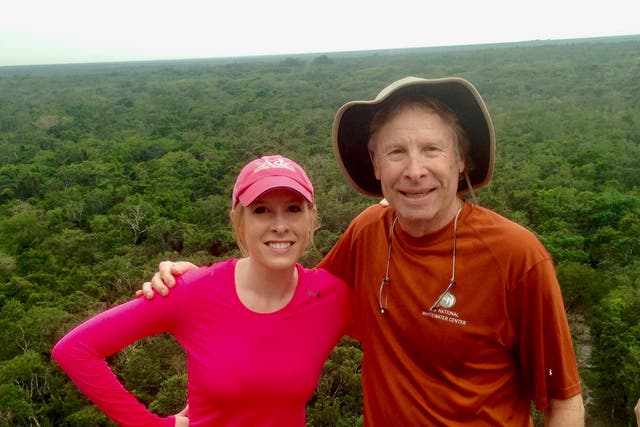 <p>Reporter Alison Parker poses on vacation with her father, Andy - who is fighting social media giants to take down videos of her murder</p>