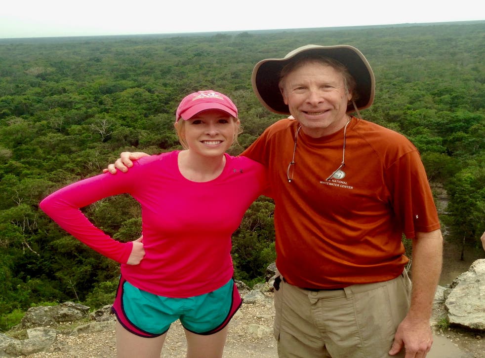 <p>Reporter Alison Parker poses on vacation with her father, Andy - who is fighting social media giants to take down videos of her murder</p>
