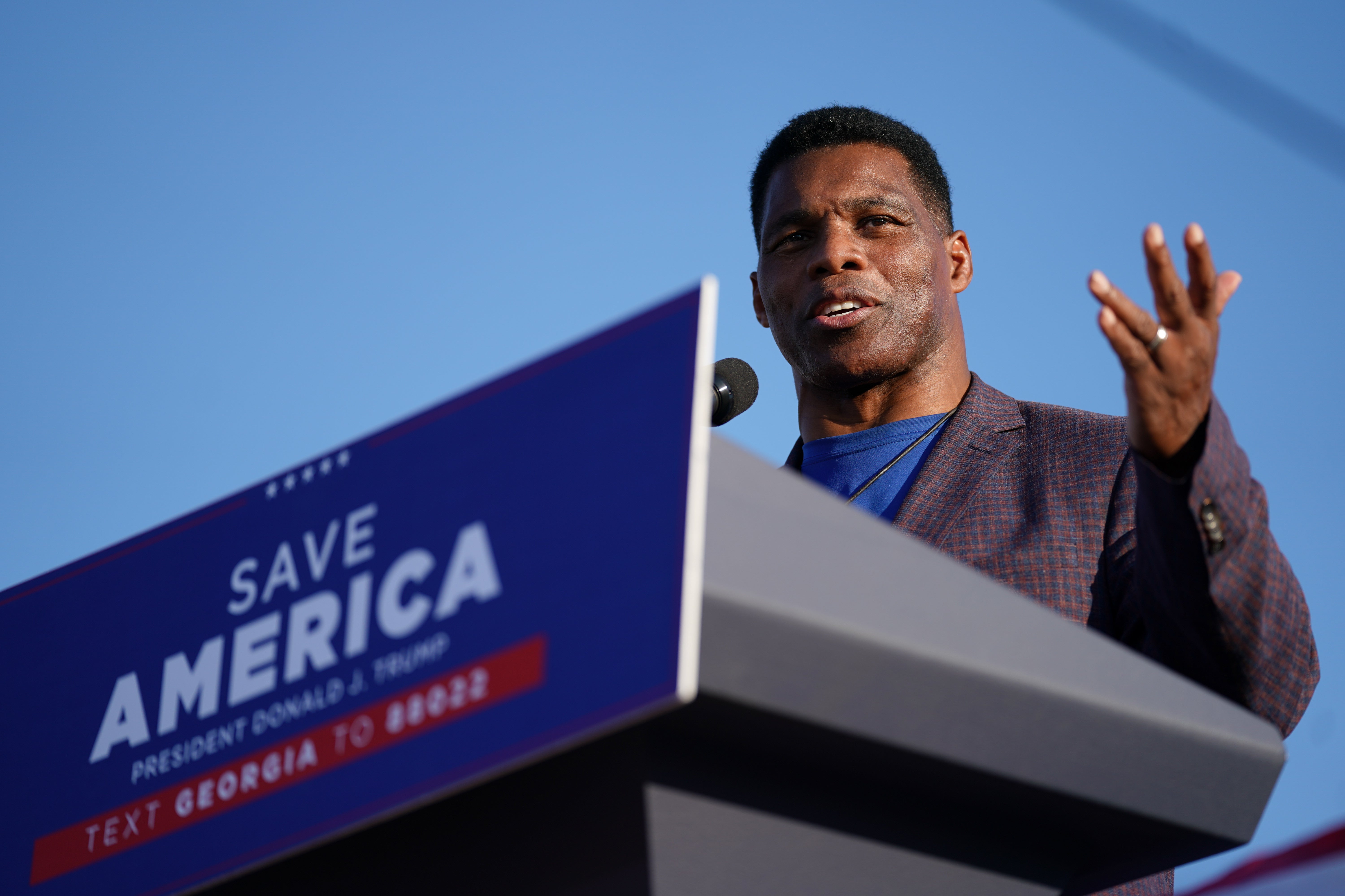 <p>Herschel Walker speaking at a rally featuring former President Donald Trump</p>