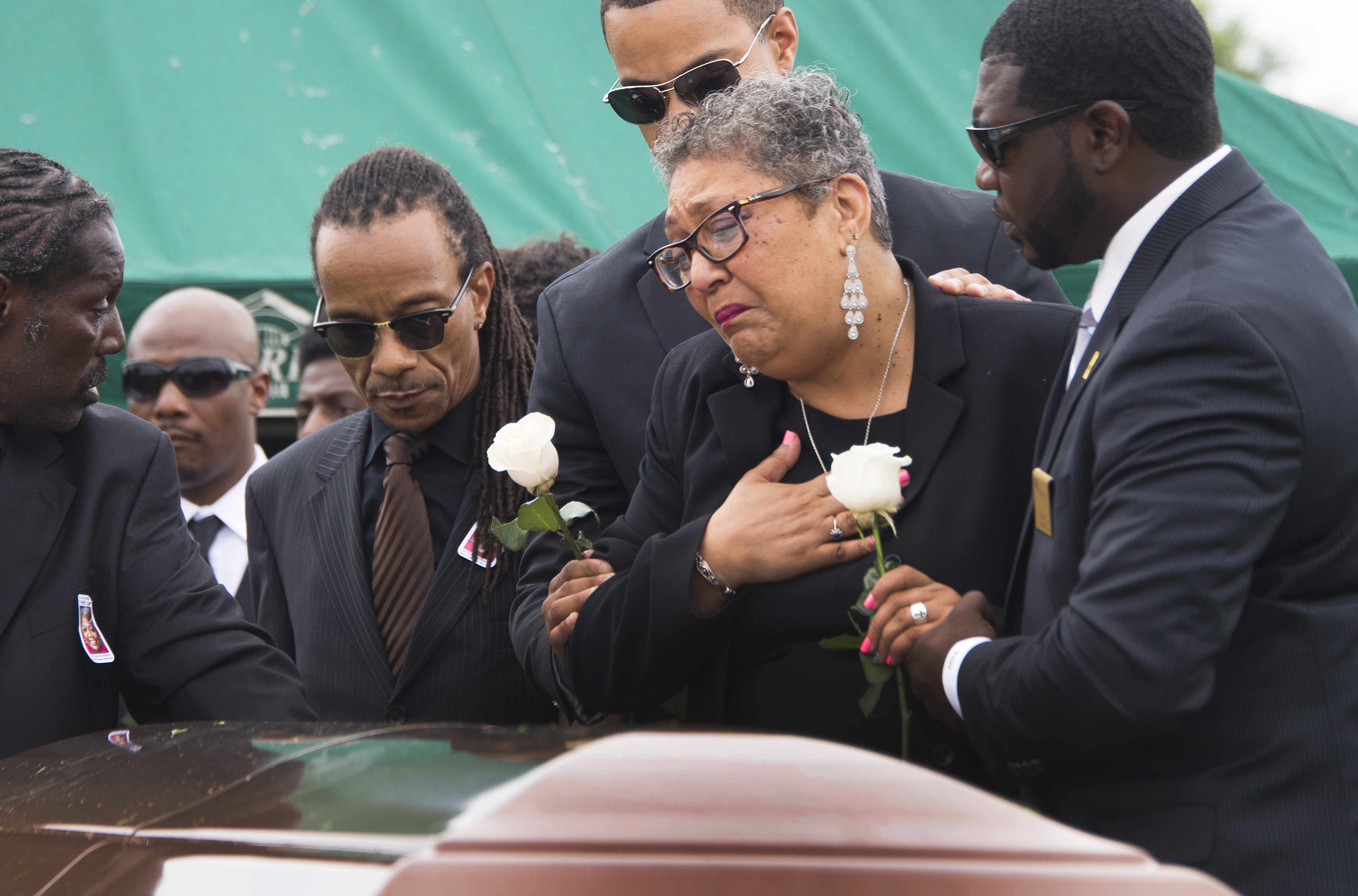 Sharon Risher and son Gary L Washington say their goodbyes to Ethel Lance during her burial at the Emanuel AME Church Cemetery in Charleston, South Carolina, on 25 June, 2015