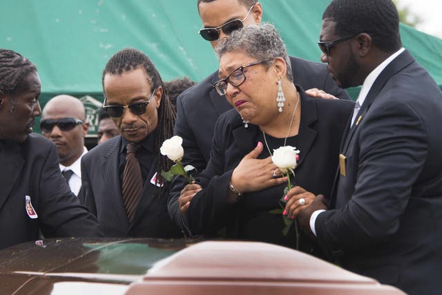 <p>Sharon Risher and son Gary L Washington say their goodbyes to Ethel Lance during her burial at the Emanuel AME Church Cemetery in Charleston, South Carolina, on 25 June, 2015</p>