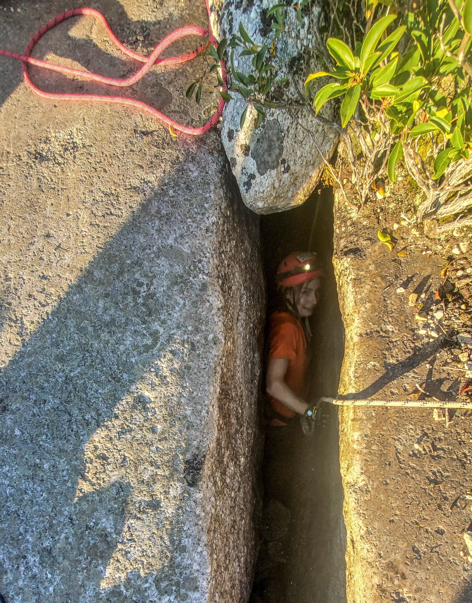 This photo provided by New York State Parks on Wednesday, Oct. 13, 2021, shows Jessica Van Ord entering a fissure to rescue a 12-year-old dog named Liza, found trapped after five days deep inside the narrow, rocky crevice at Minnewaska State Park Preserve in Kerhonkson, N.Y.