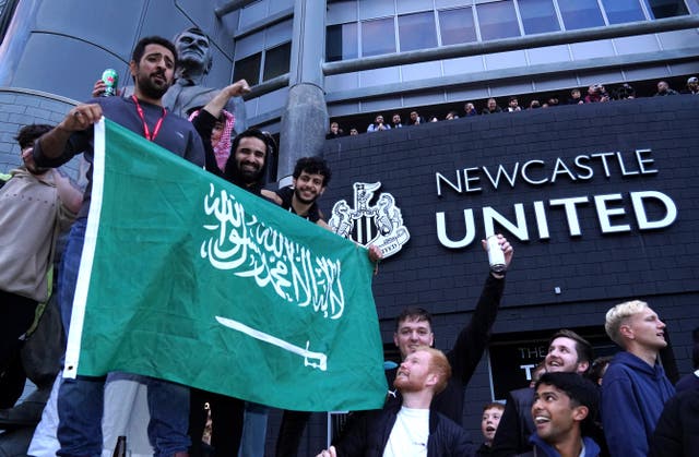 Newcastle fans pictured celebrating the Saudi-backed consortium takeover of the club (Owen Humphreys/PA)