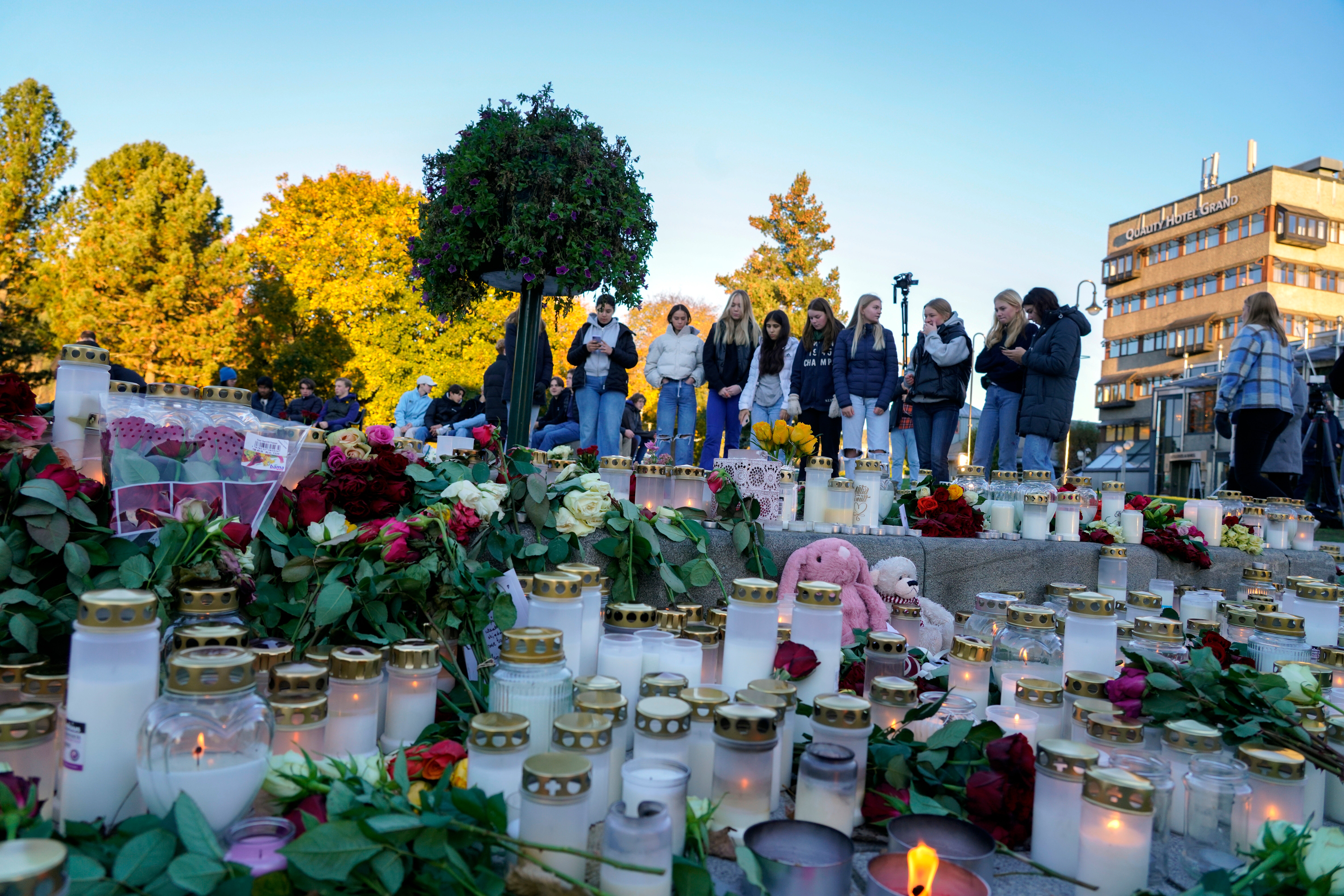 People pay their respects to the victims of the attack in Kongsberg, Norway.