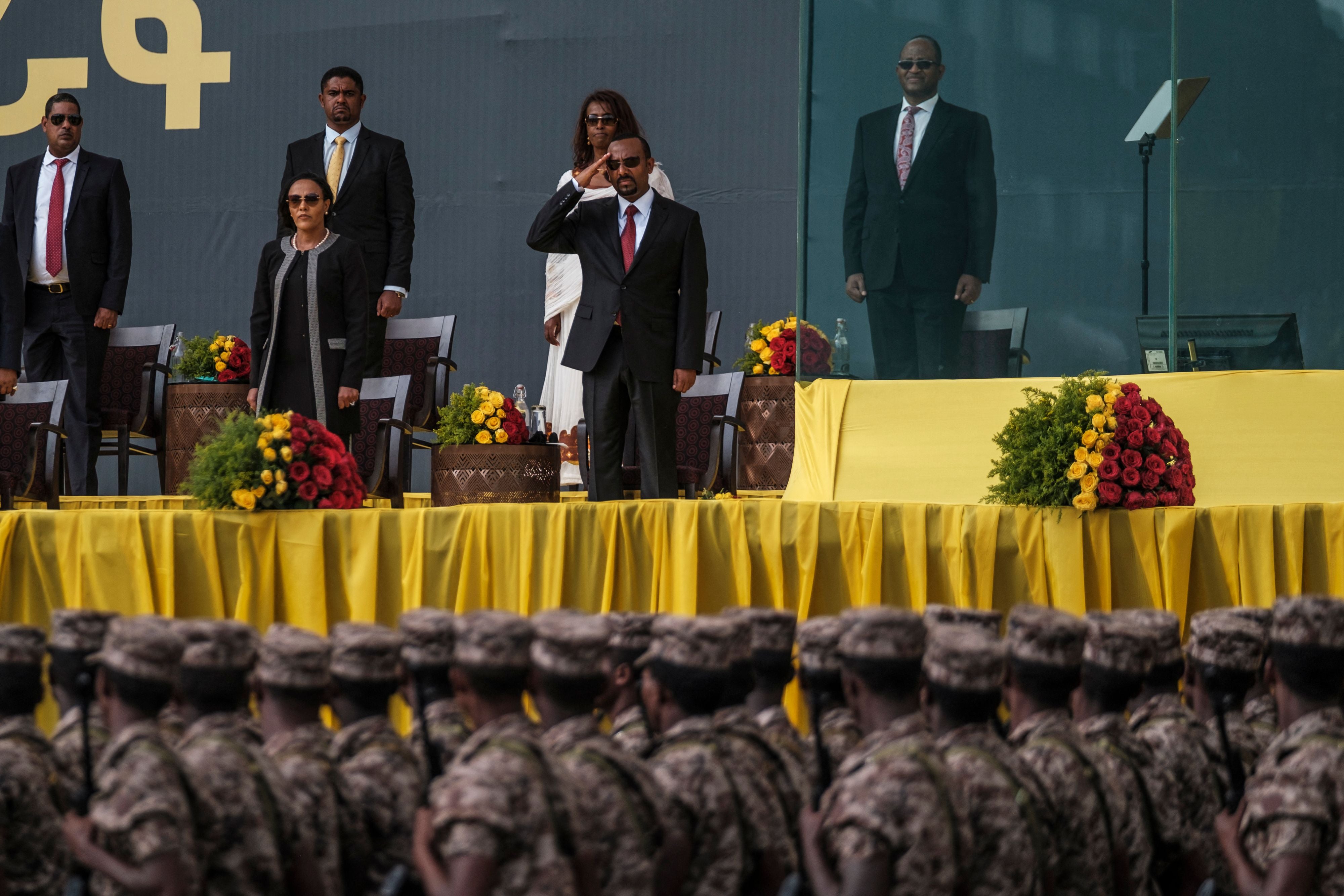 Ethiopian prime minister Abiy Ahmed (1st row, R) salutes members of the national defence forces