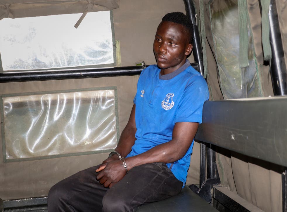 <p>Masten Wanjala sat in the back of a police truck being taken by police to identify the location of alleged victim remains.</p>