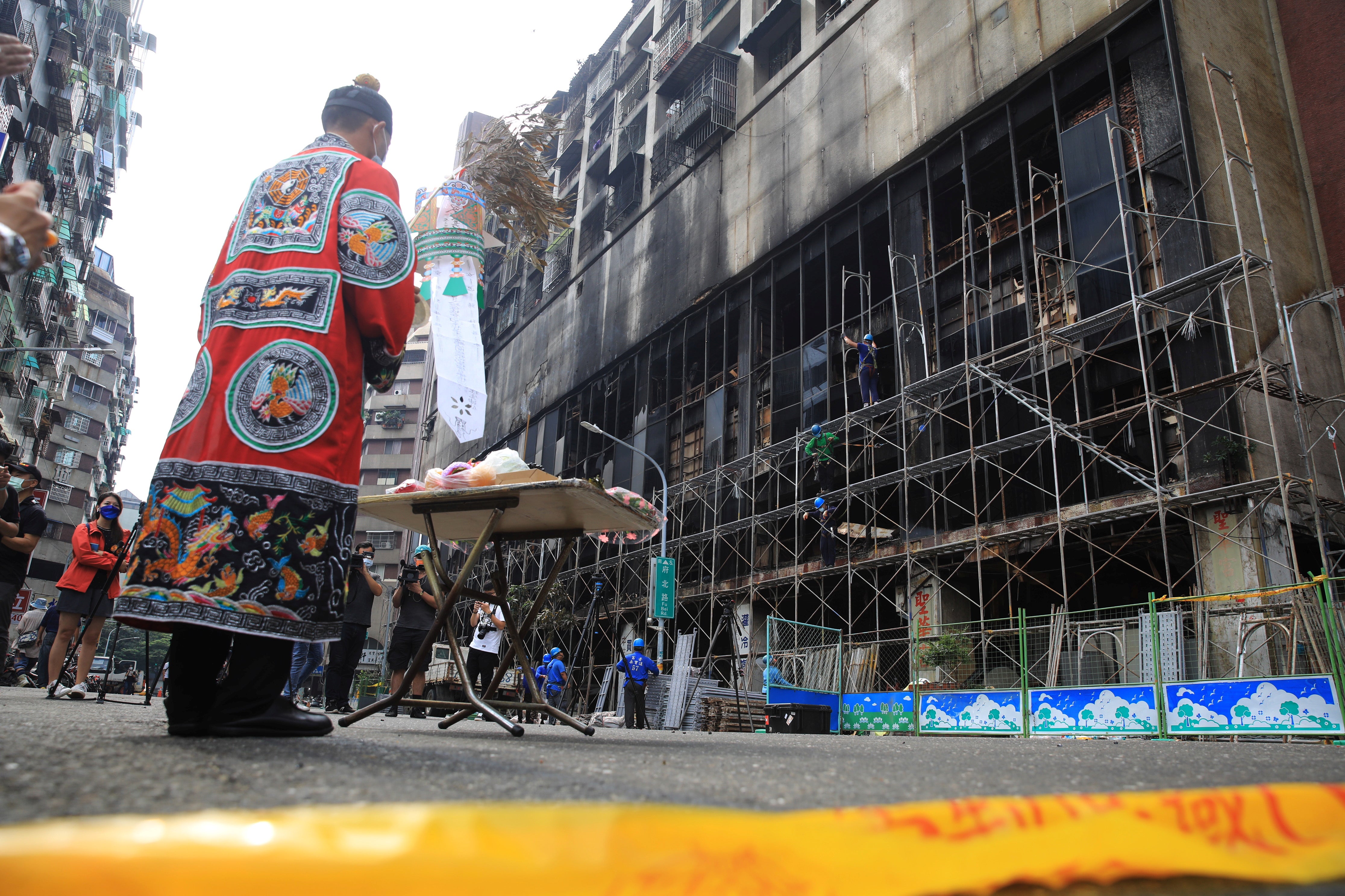 Taoist priest holds a ceremony for the victims after a fire broke out in a residential building in Kaohsiung