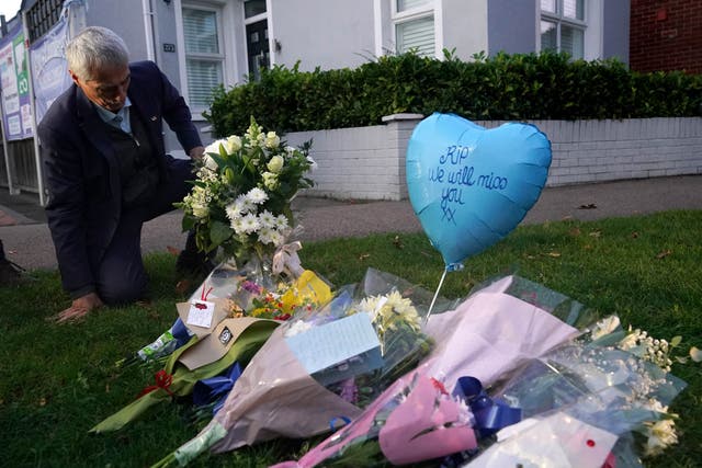 <p>A man lays flowers in memory of Sir David Amess in Leigh-on-Sea </p>