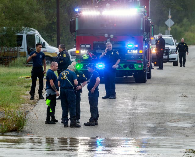 <p>Emergency personnel work at a flooded creek, Thursday, Oct. 14, 2021, in St. Hedwig, Texas, after the remnants of Hurricane Pamela swept away several cars and left two people missing.</p>