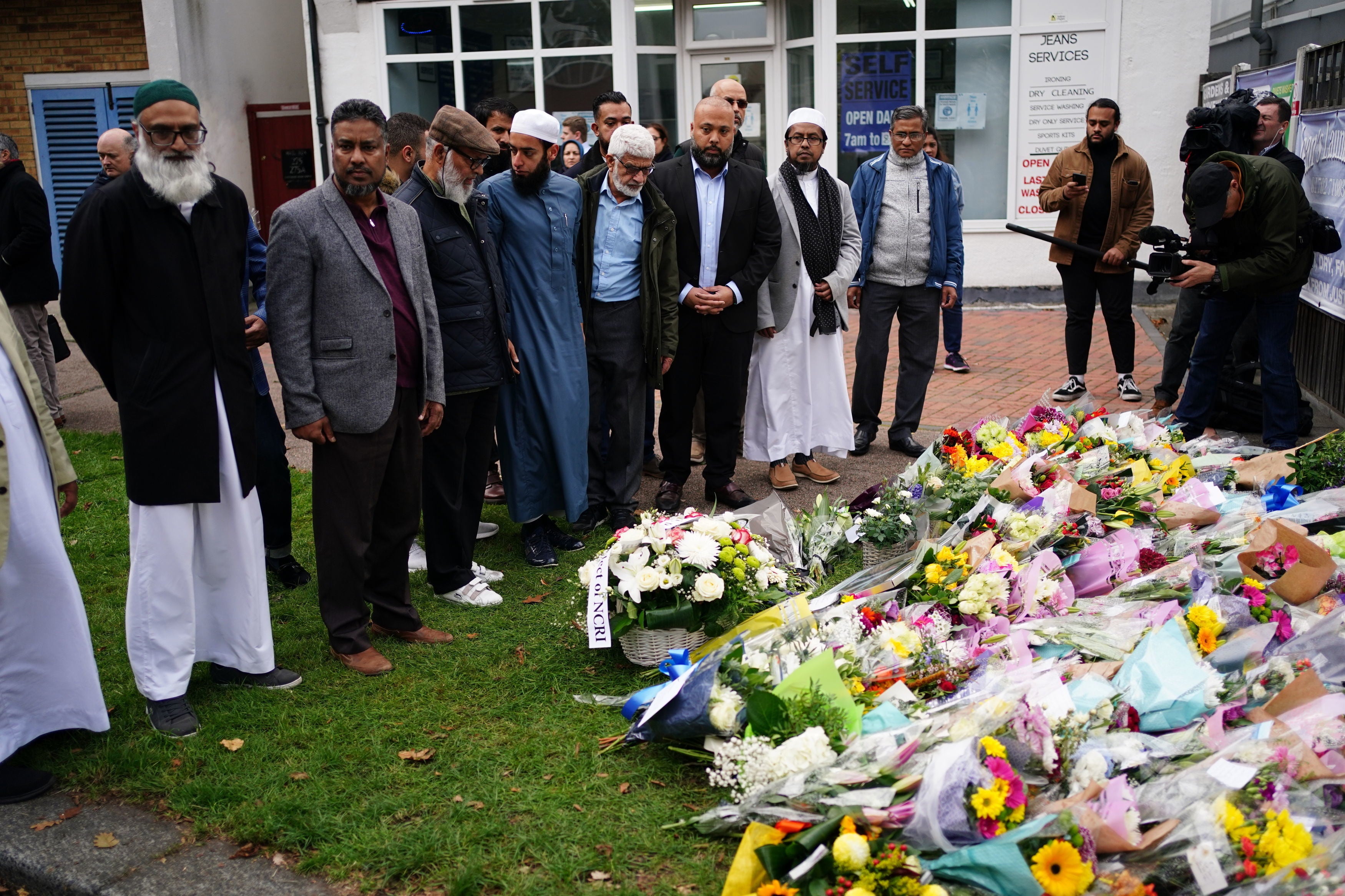 Leaders from Southend mosques lay flowers near Belfairs Methodist Church in Leigh-on-Sea on Saturday