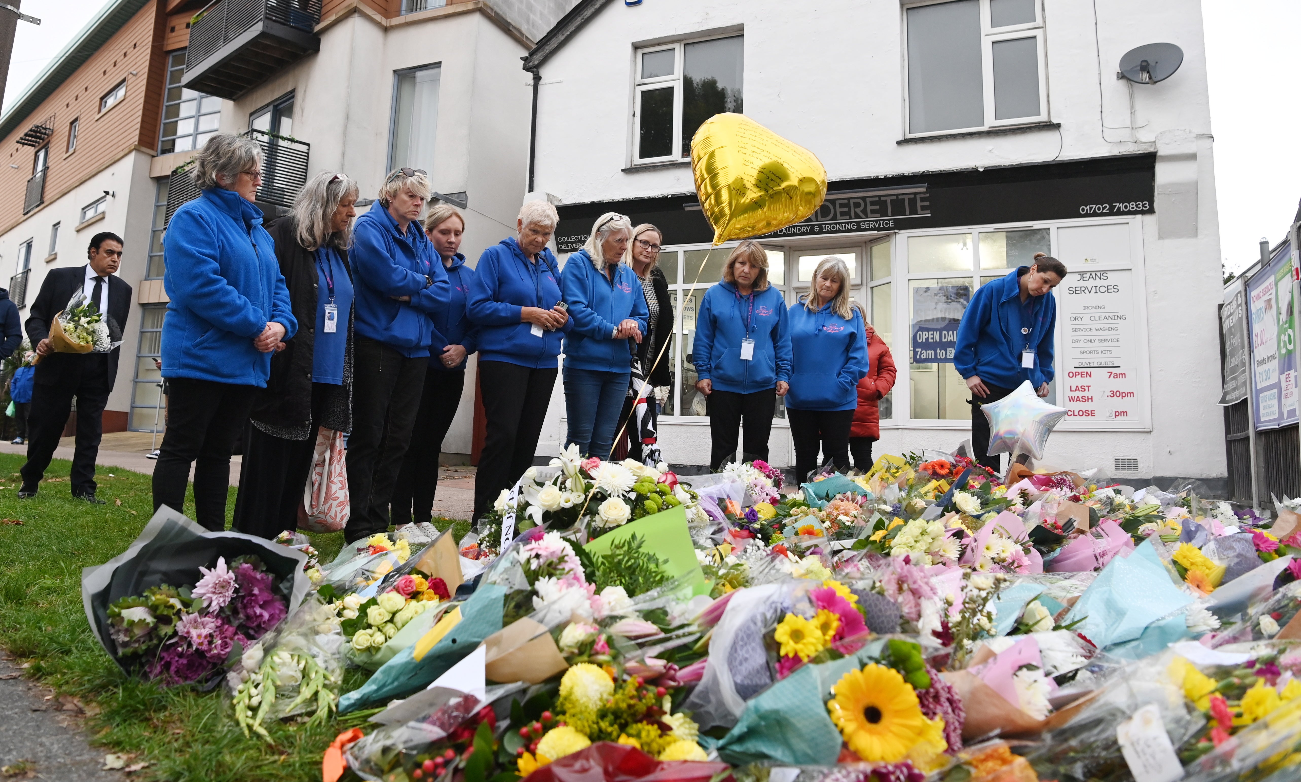 <p>Members of the public leave flowers in tribute to Sir David Amess </p>