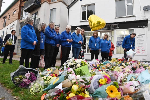 <p>Members of the public leave flowers in tribute to Sir David Amess </p>