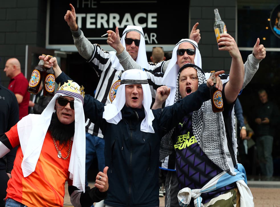 <p>Newcastle fans pose outside St James’ Park</p>