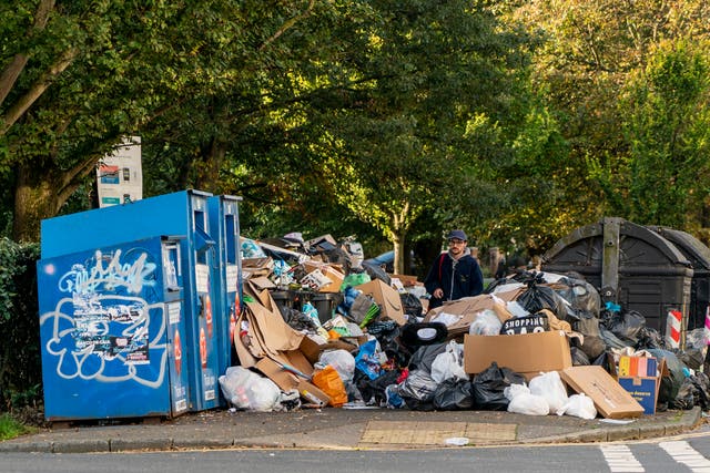 <p>A man picks his way through the growing mountain of rubbish in Montpellier Terrace as the Brighton bin strike continues.</p>