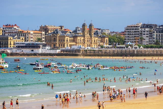 <p>San Sebastian’s La Concha beach is a big draw for UK tourists – if they can still get there</p>