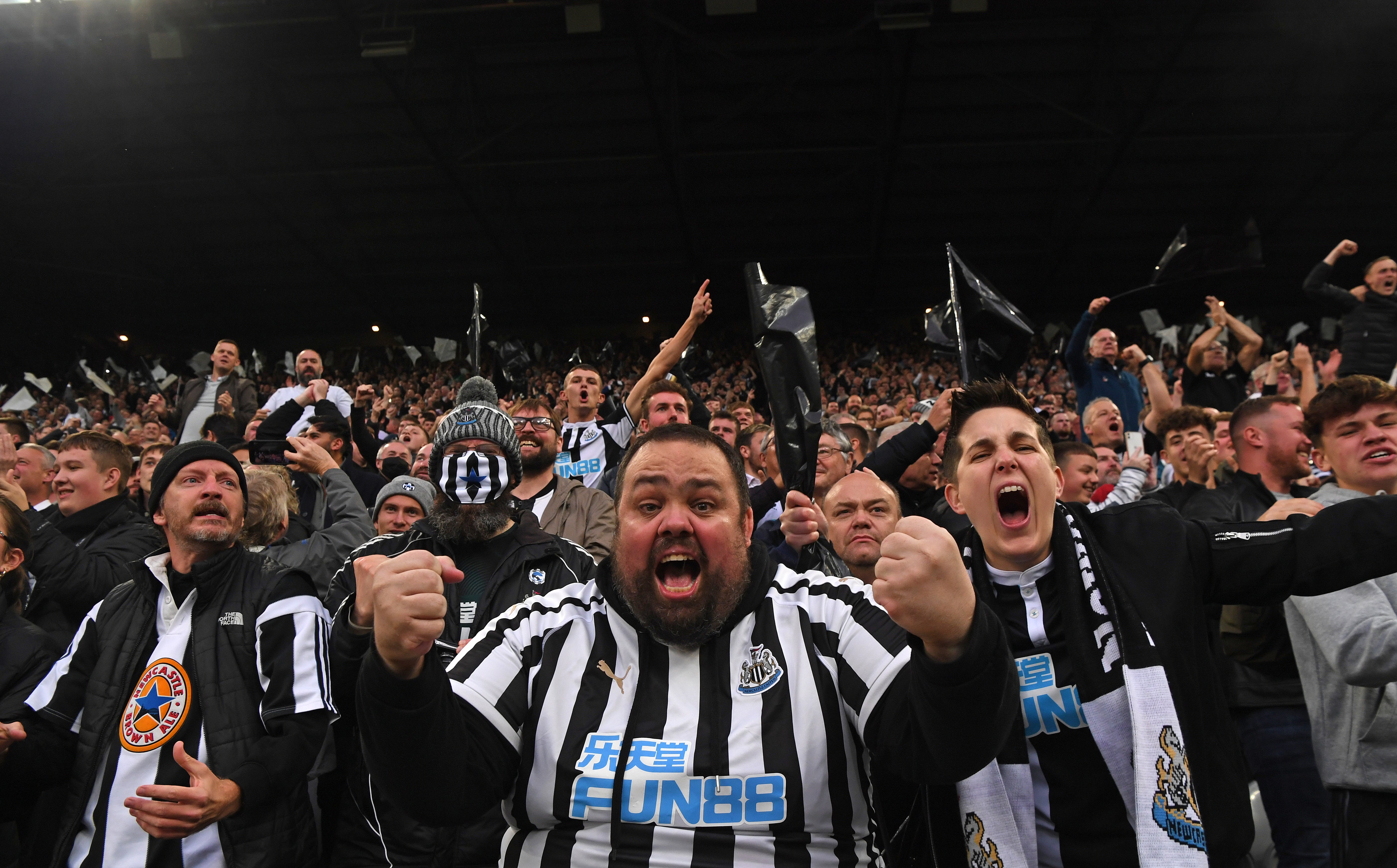 Newcastle fans in the Gallowgate End celebrate the opening goal scored by Callum Wilson