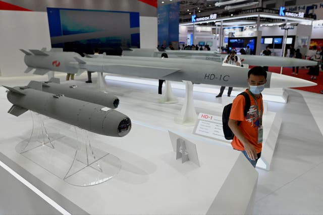 <p>File. A man walks among supersonic cruise missiles at the 13th China International Aviation and Aerospace Exhibition in Zhuhai</p>