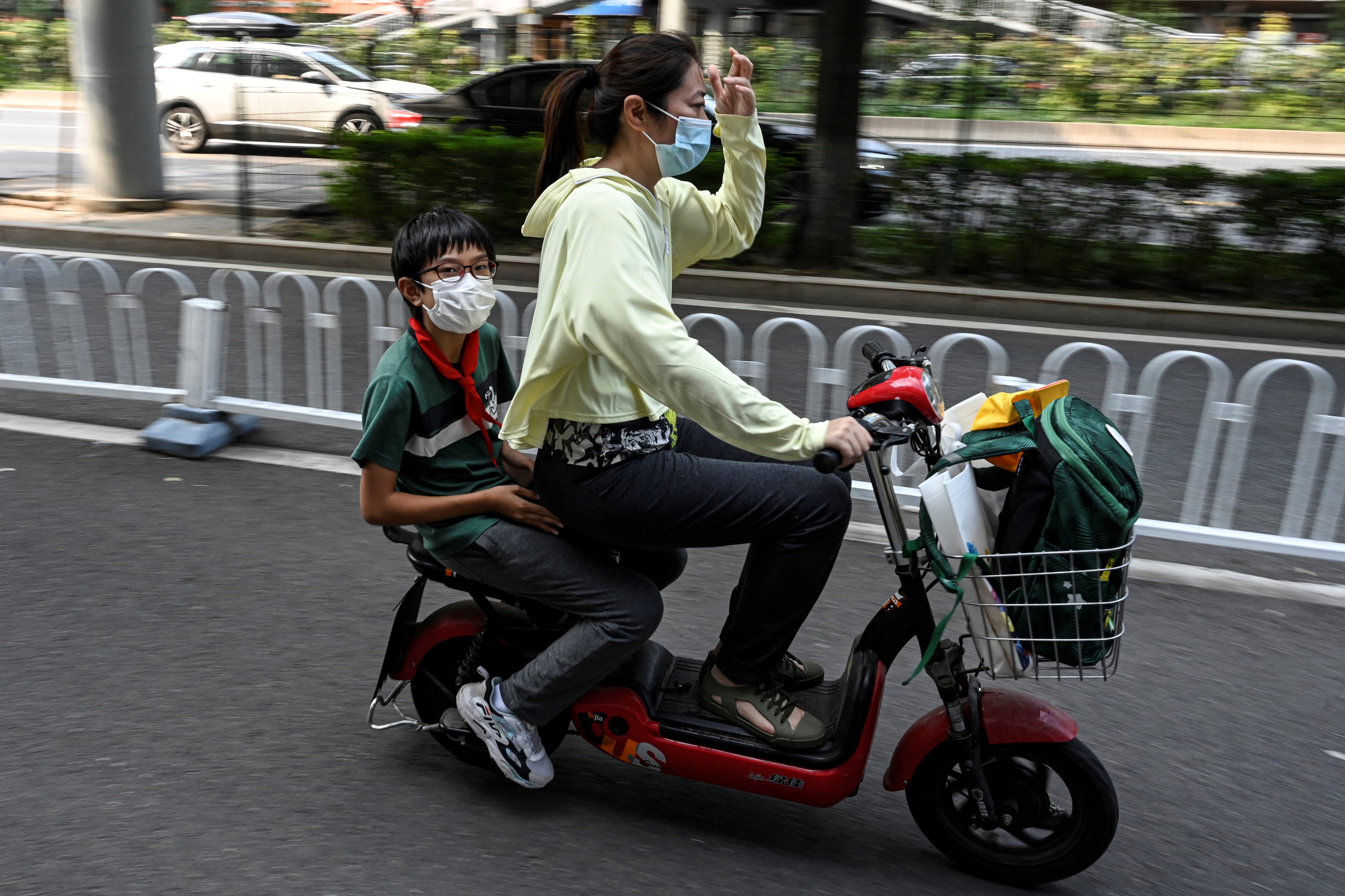 File: A student leaves on a scooter following the end of the day’s school session in Beijing on 10 September 2021