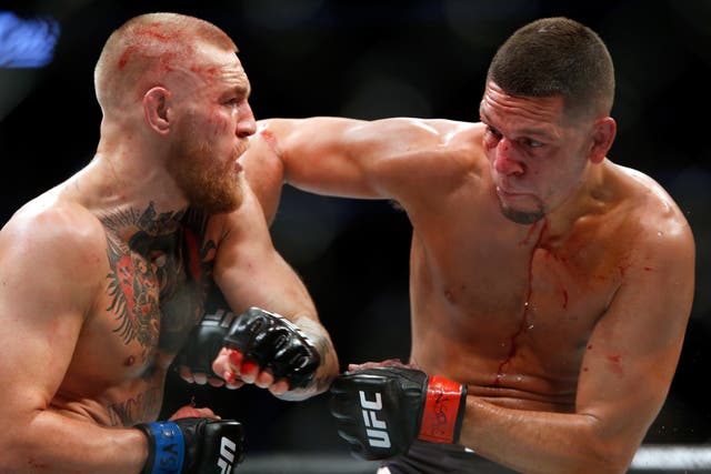 <p>Conor McGregor and Nate Diaz battle during their welterweight rematch at the UFC 202 in 2016</p>