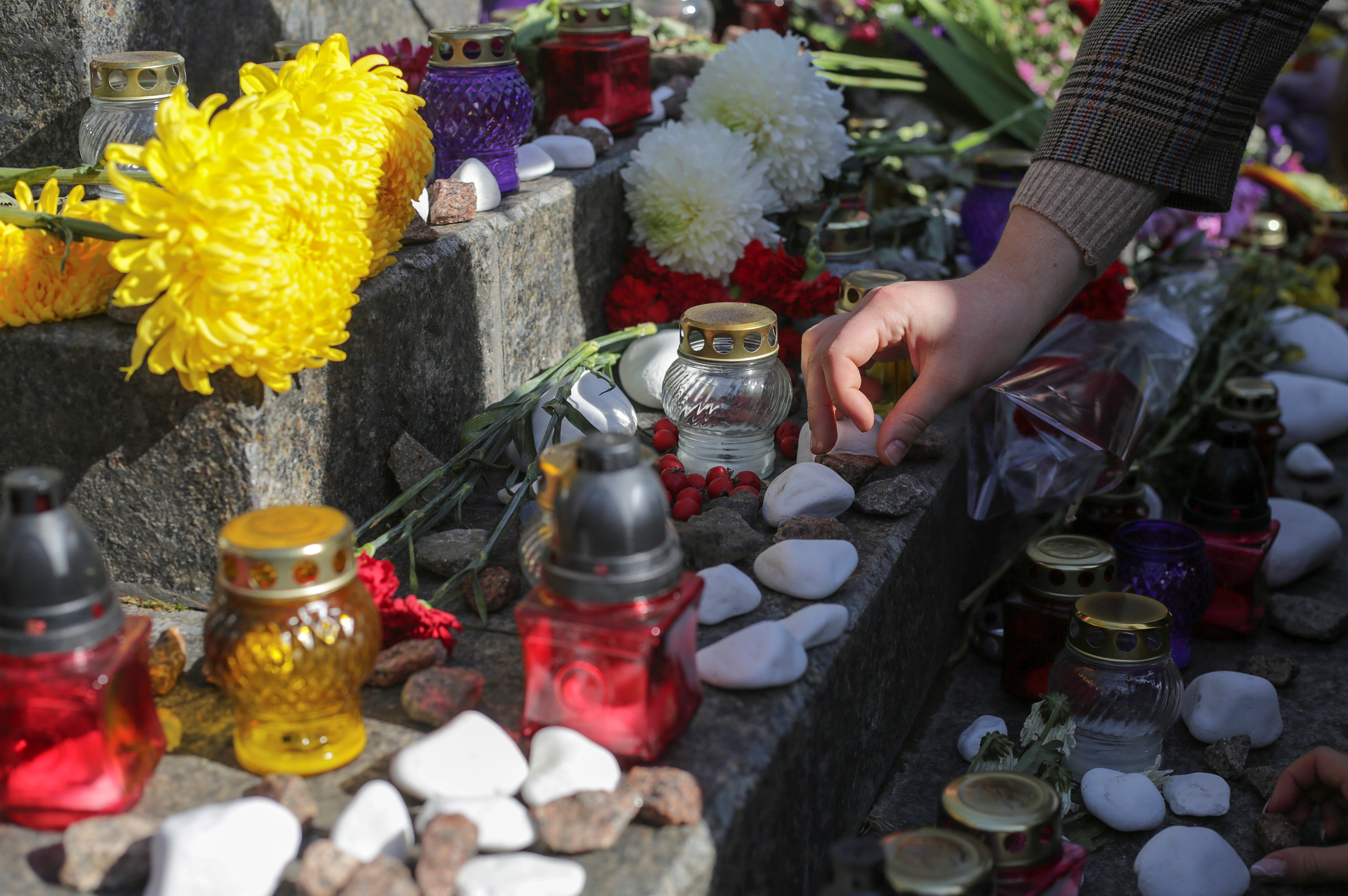 A participant places a stone during the March of Remembrance to commemorate the victims of Babyn Yar earlier this month