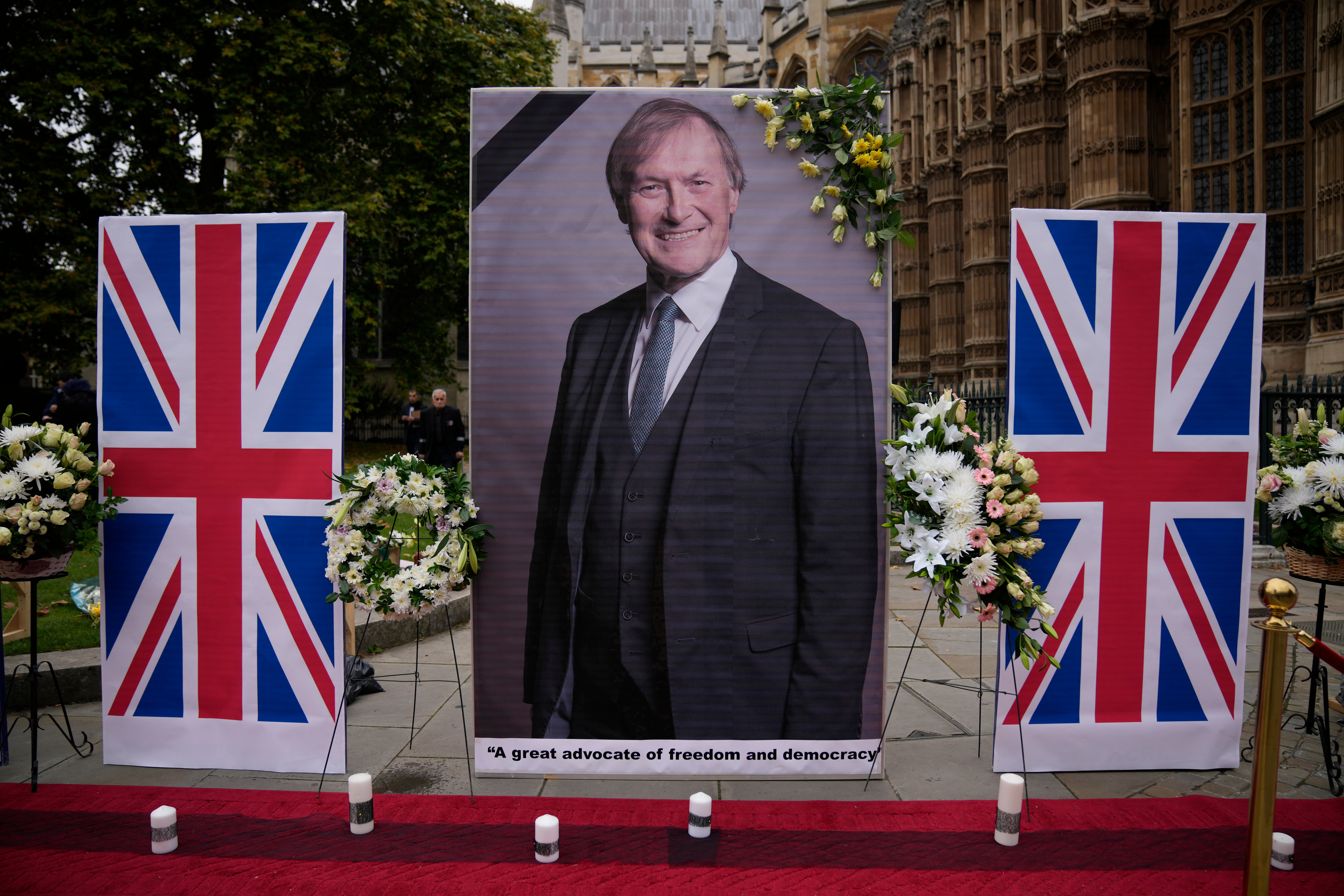 An image of Sir David Amess opposite the Houses of Parliament, placed in tribute to the MP who was killed while during a constituency surgery