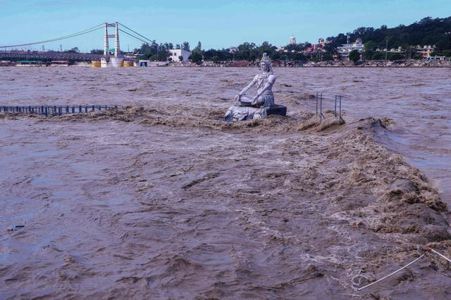 <p>A statue of Hindu god Lord Shiva is pictured amid the risen water levels of River Ganga after incessant rains in Rishikesh </p>