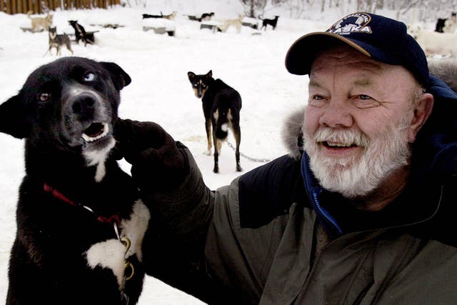 <p>Paulsen sits with his favourite Alaskan husky, Flax, at his Willow, Alaska, home in 2005</p>