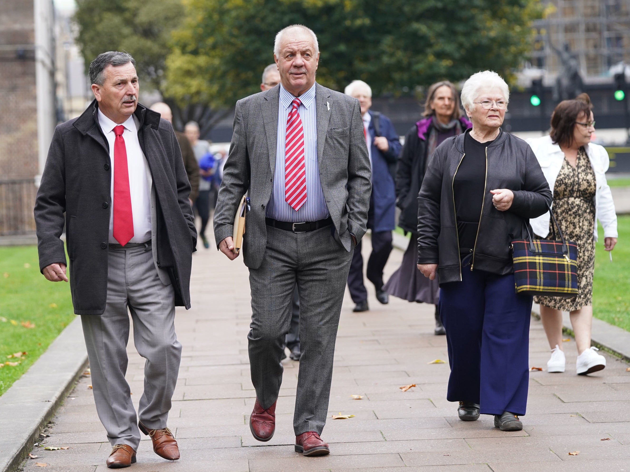 McCord (centre) leads victims of the Troubles and their families through Parliament Square, Westminster, on Tuesday