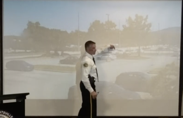 <p>Huntsville PD Deputy Chief Dewayne McCarver points out Ms Nance entering the police van</p>