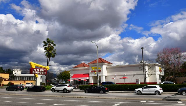 <p>Representative: Social distancing by cars is seen in the drive-thru line of an In-N-Out burger restaurant in Alhambra, California on 25 March 2020  </p>