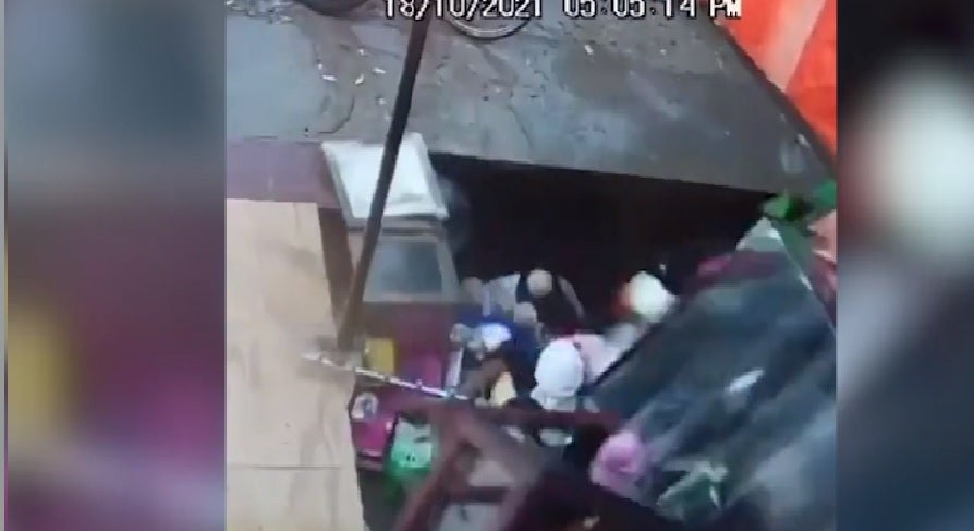 <p>Screengrab: CCTV video showing a massive sinkhole swallowing a shop full of customers in northern India</p>