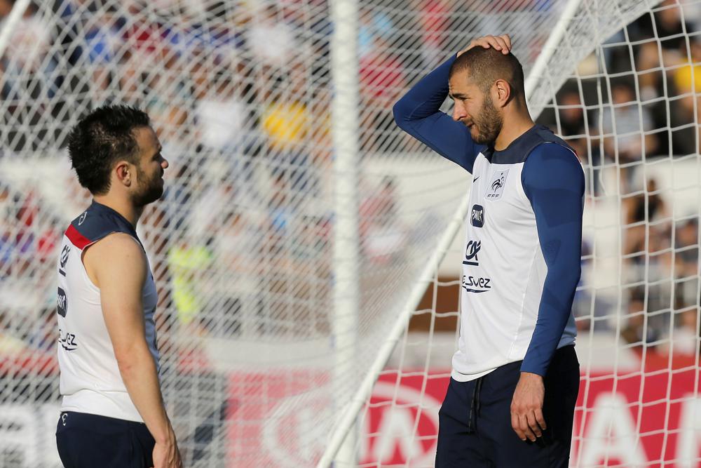 France’s Mathieu Valbuena, left, and Karim Benzema, right, chat during a training session of the French national soccer team in Brazil in 2014