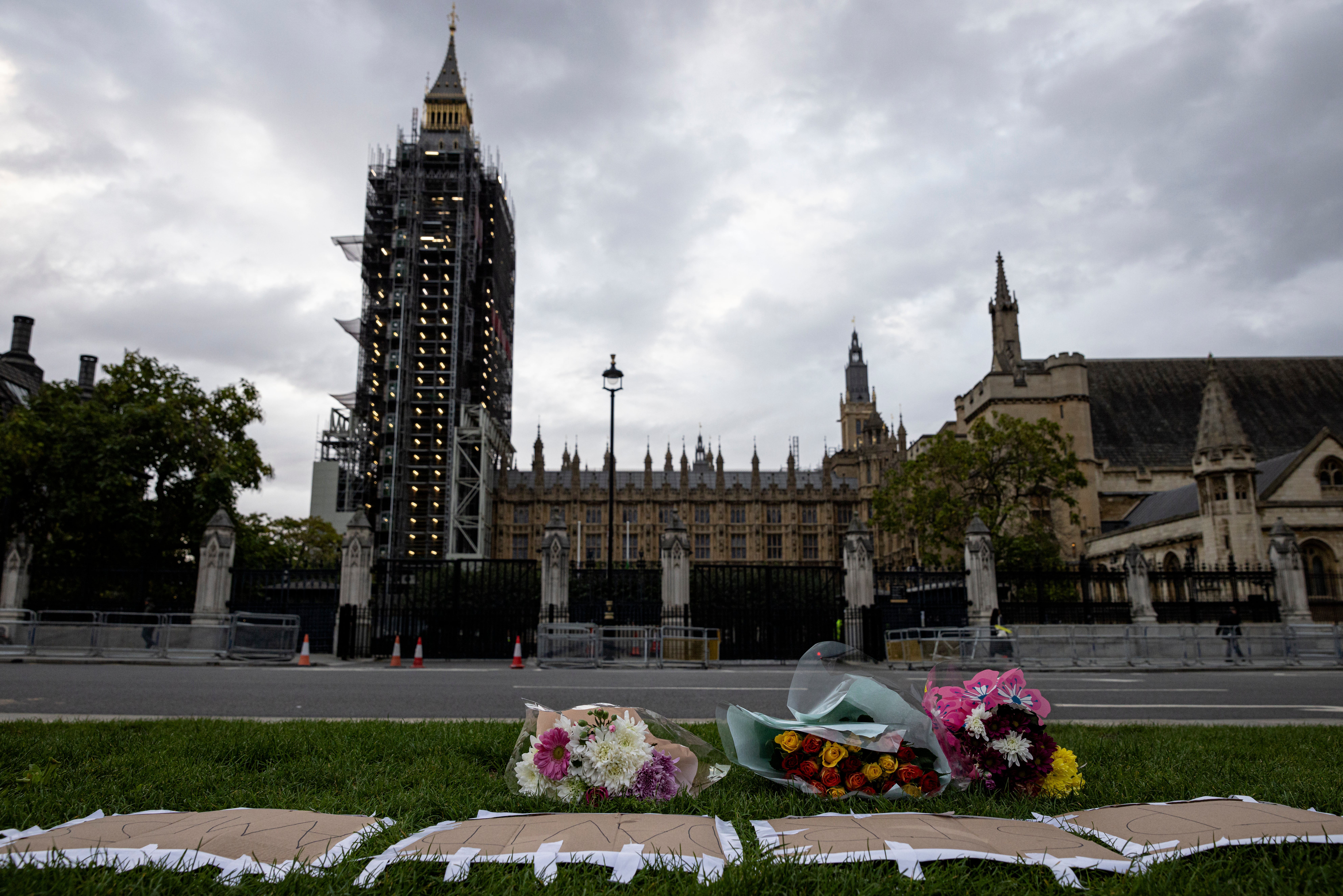 Floral tributes are left in Parliament Square for Sir David Amess MP. His killing prompted Priti Patel to announce a security review for MPs