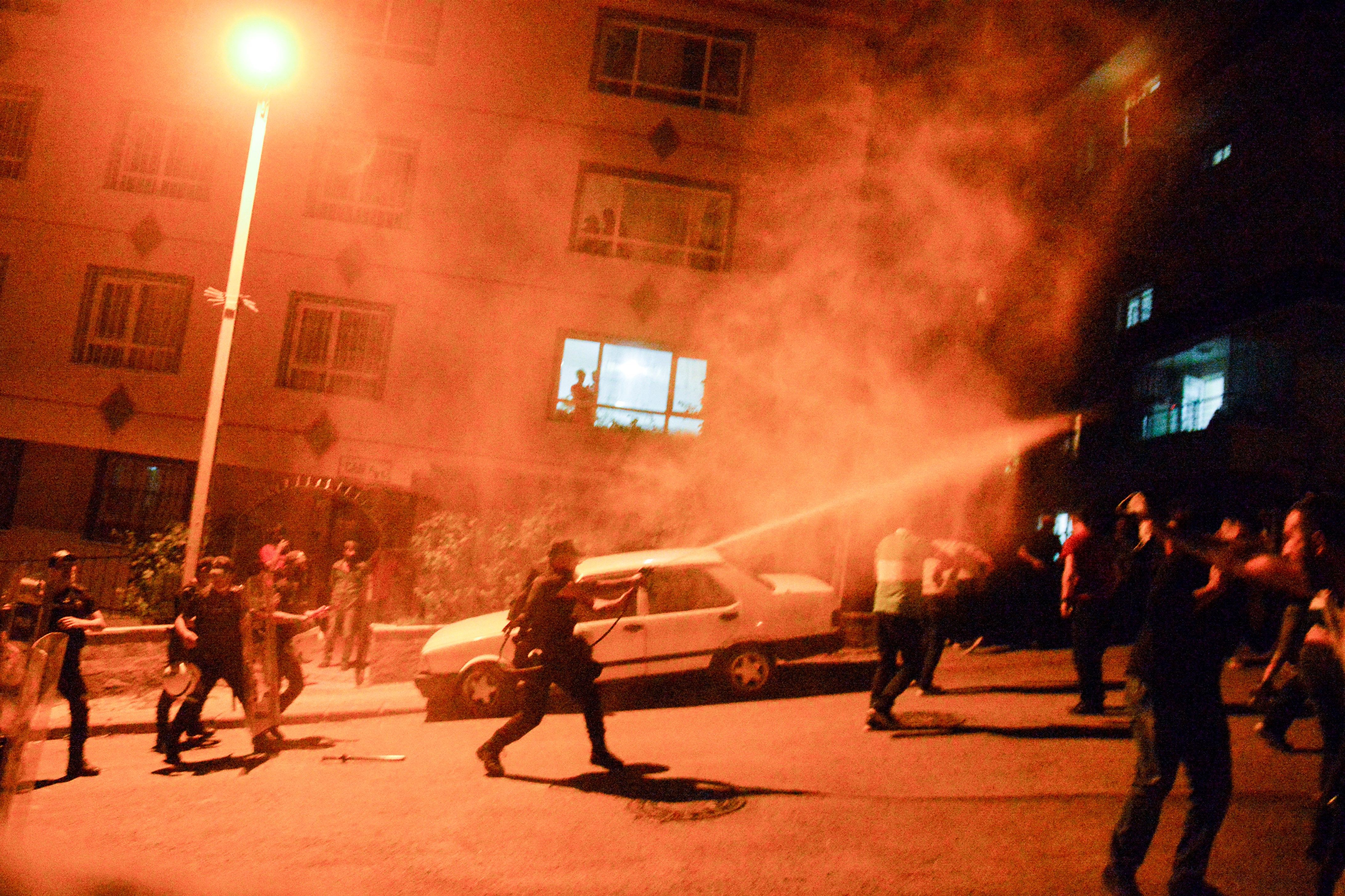 Turkish police use teargas to disperse men smashing up shops and homes believed to be owned by Syrian families