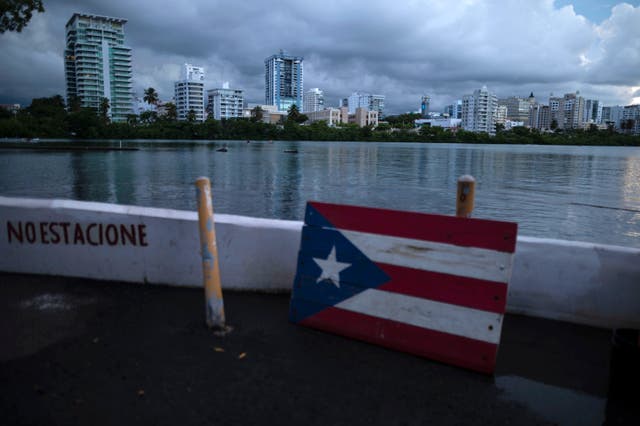 <p>A wooden Puerto Rican flag is displayed on the dock of the Condado lagoon, where multiple selective blackouts have been recorded in the past days, in San Juan, Puerto Rico, Thursday, Sept. 30, 202</p>
