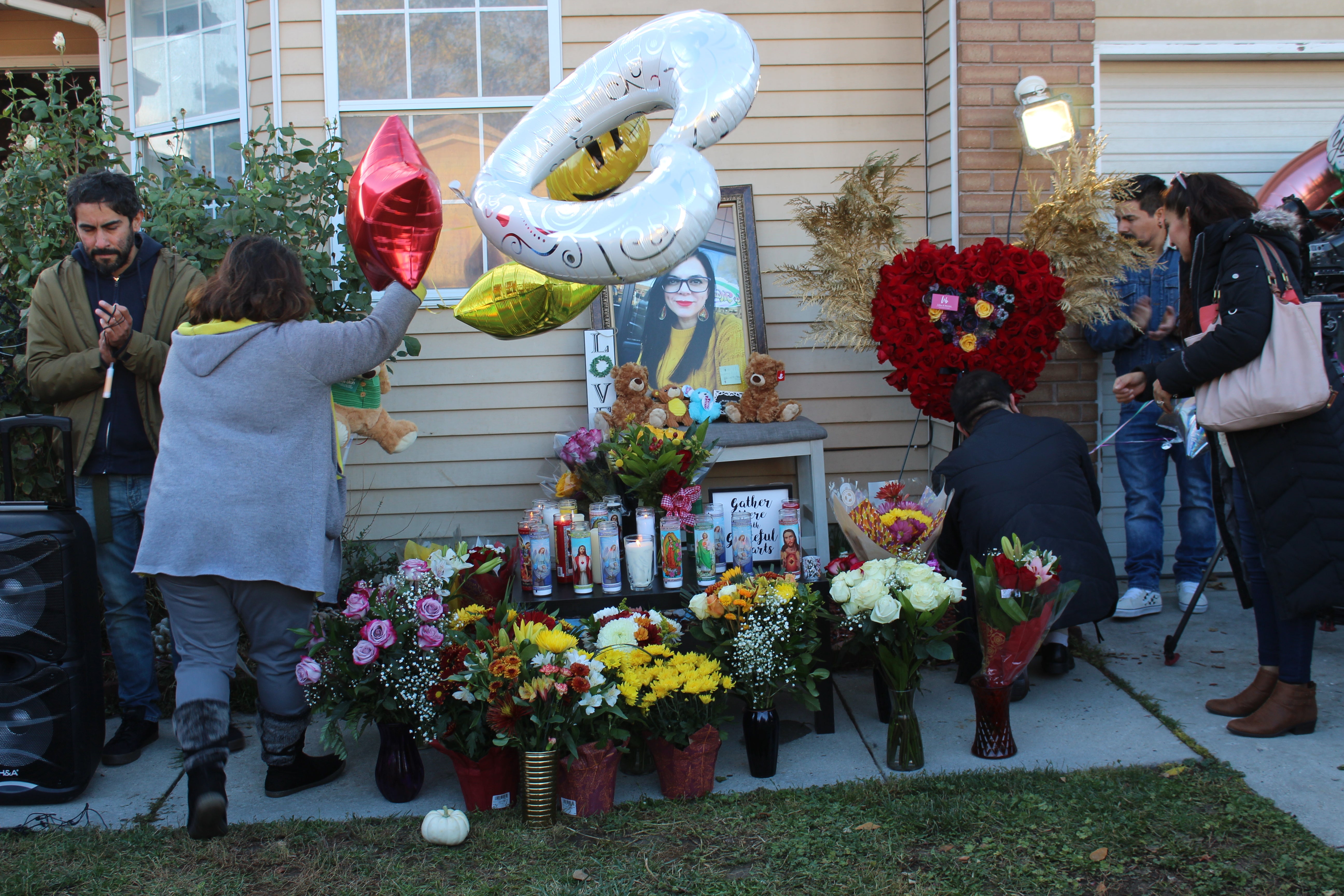 Friends and family of Gaby Ramos place floral bouquets and balloons at a makeshift altar outside the slain radio personality’s home on Tuesday, 19 October.