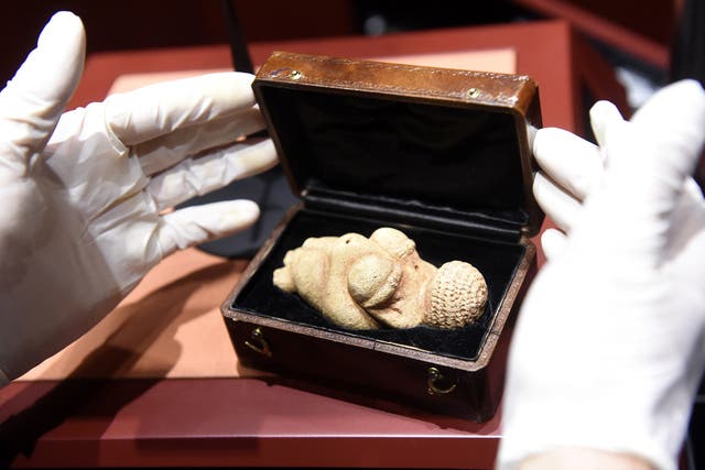 <p>File: This undated picture released on 28 February 2018 shows the hands of a person opening a box containing the ‘Venus of Willendorf’ figurine at the Nature Historical Museum, that was censored by Facebook</p>