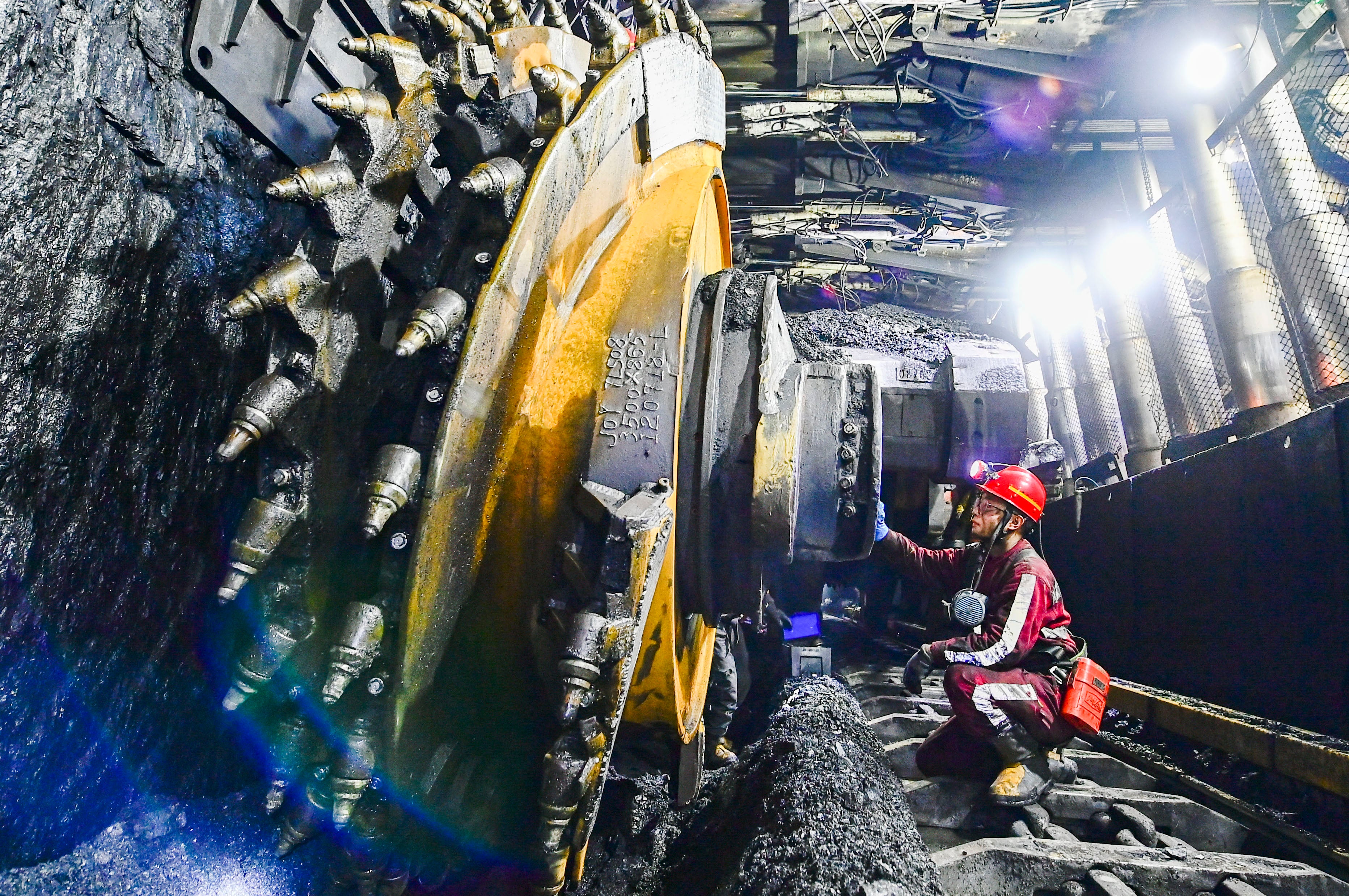 A worker checks equipment at a coal mine in Ordos, Inner Mongolia, China. Reducing demand for coal is crucial for meeting climate targets, say scientists