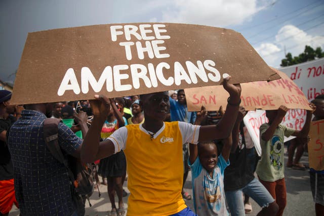 <p>People protest for the release of kidnapped missionaries near the missionaries' headquarters in Titanyen, north of Port-au-Prince, Haiti, Tuesday, Oct. 19, 2021. </p>