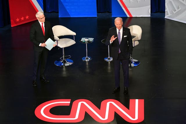 <p>US president Joe Biden participates in a CNN town hall hosted by anchor Anderson Cooper (L) at Baltimore Centre Stage in Baltimore, Maryland on 21 October 2021</p>