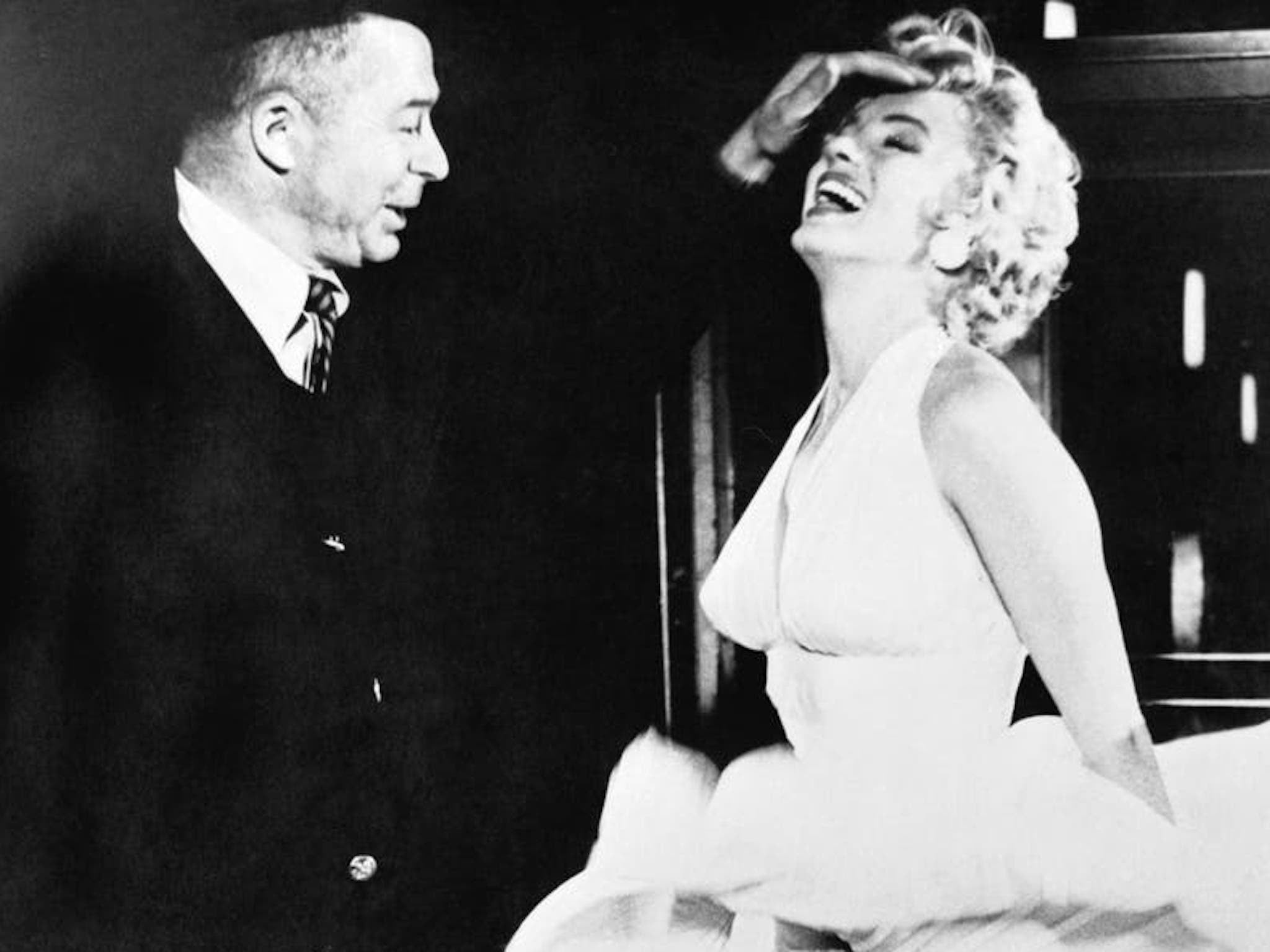 Billy Wilder and Marilyn Monroe, whose skirt is being blown up by a fan, on the set of his romantic comedy ‘The Seven Year Itch’ in 1955