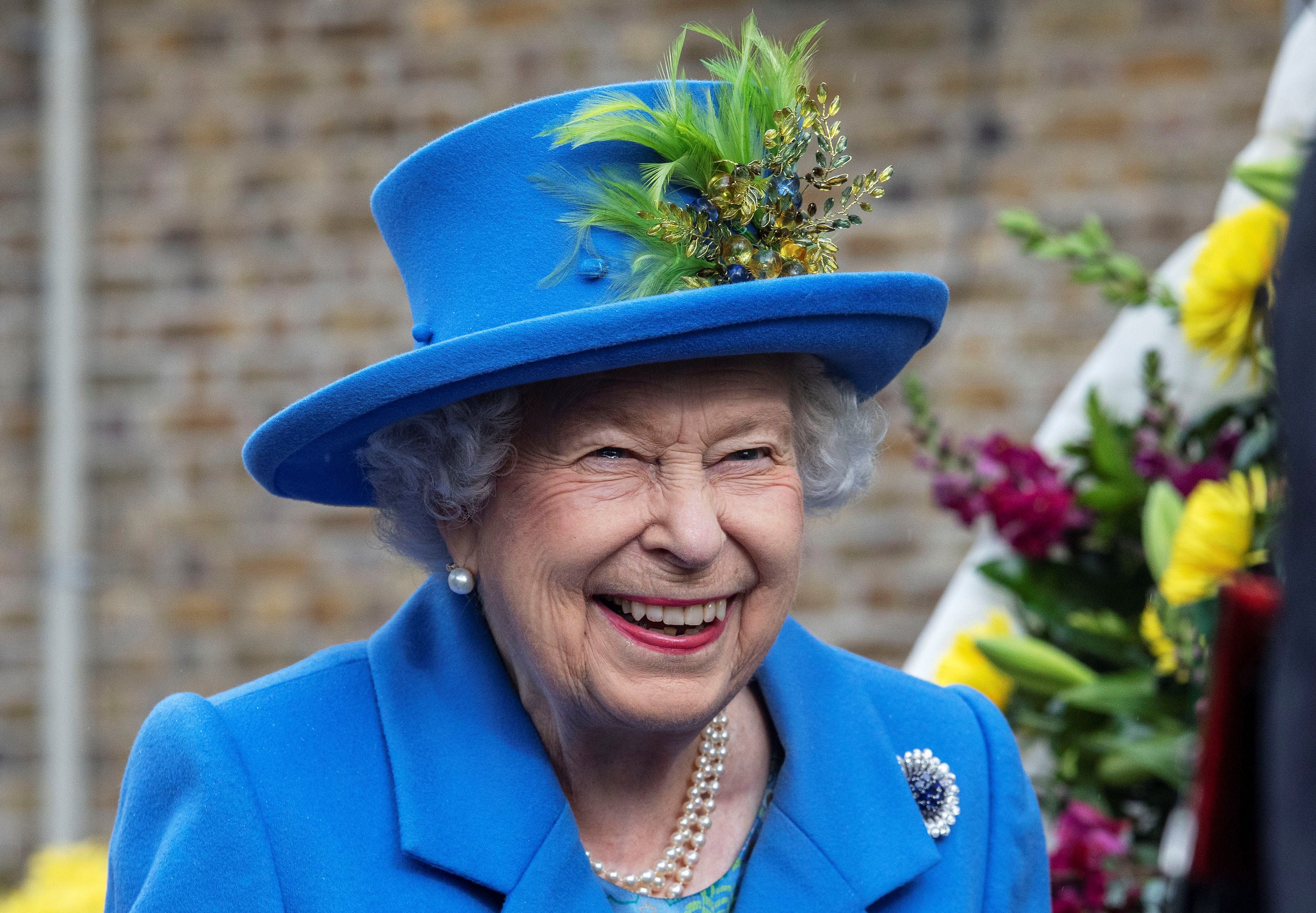 Queen Elizabeth II reacts as she visits the Haig Housing Trust in Morden in 2019