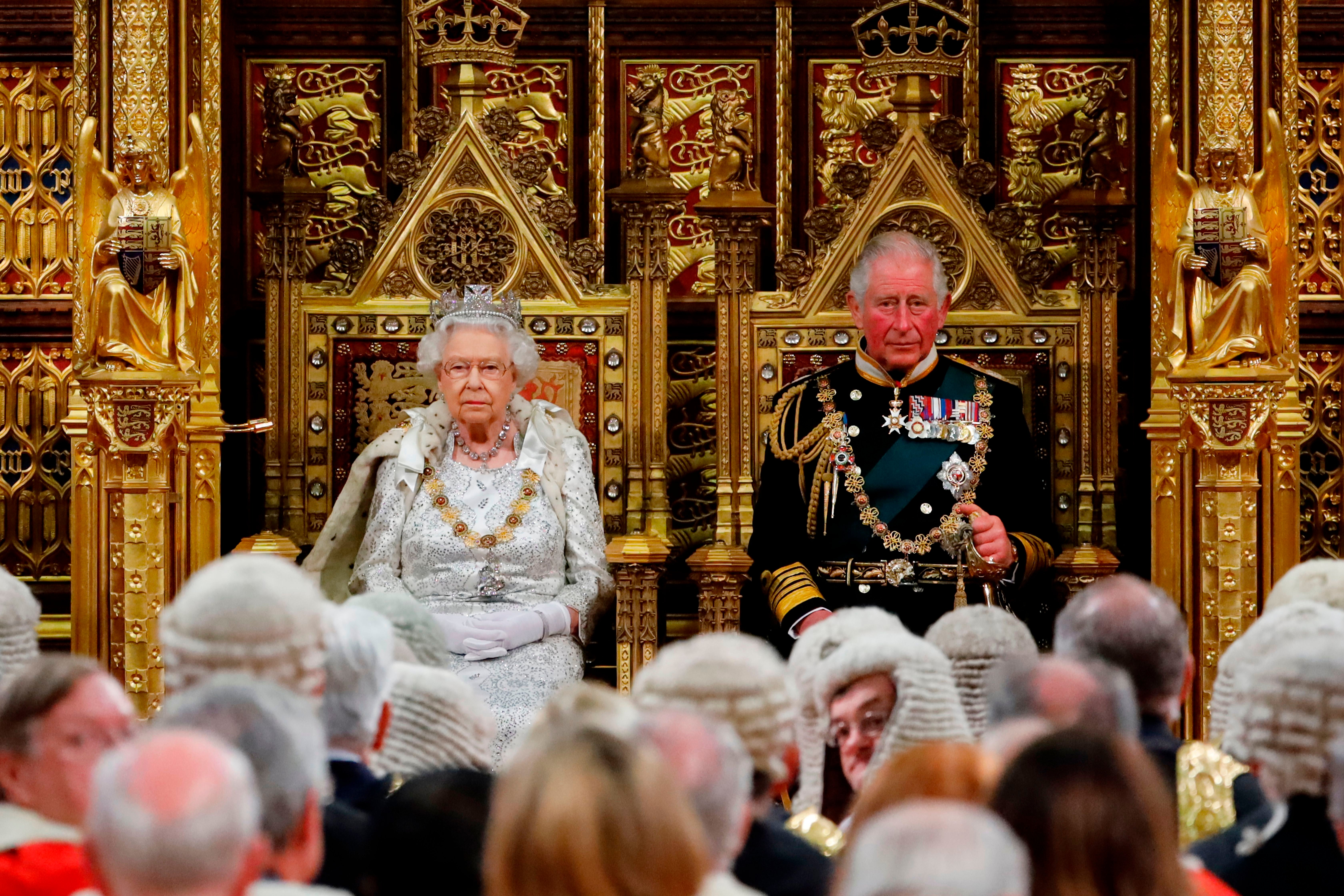 Queen Elizabeth II takes her seat on the The Sovereign's Throne in the House of Lords next to Prince Charles, before reading the Queen's Speech during the State Opening of Parliament in 2019