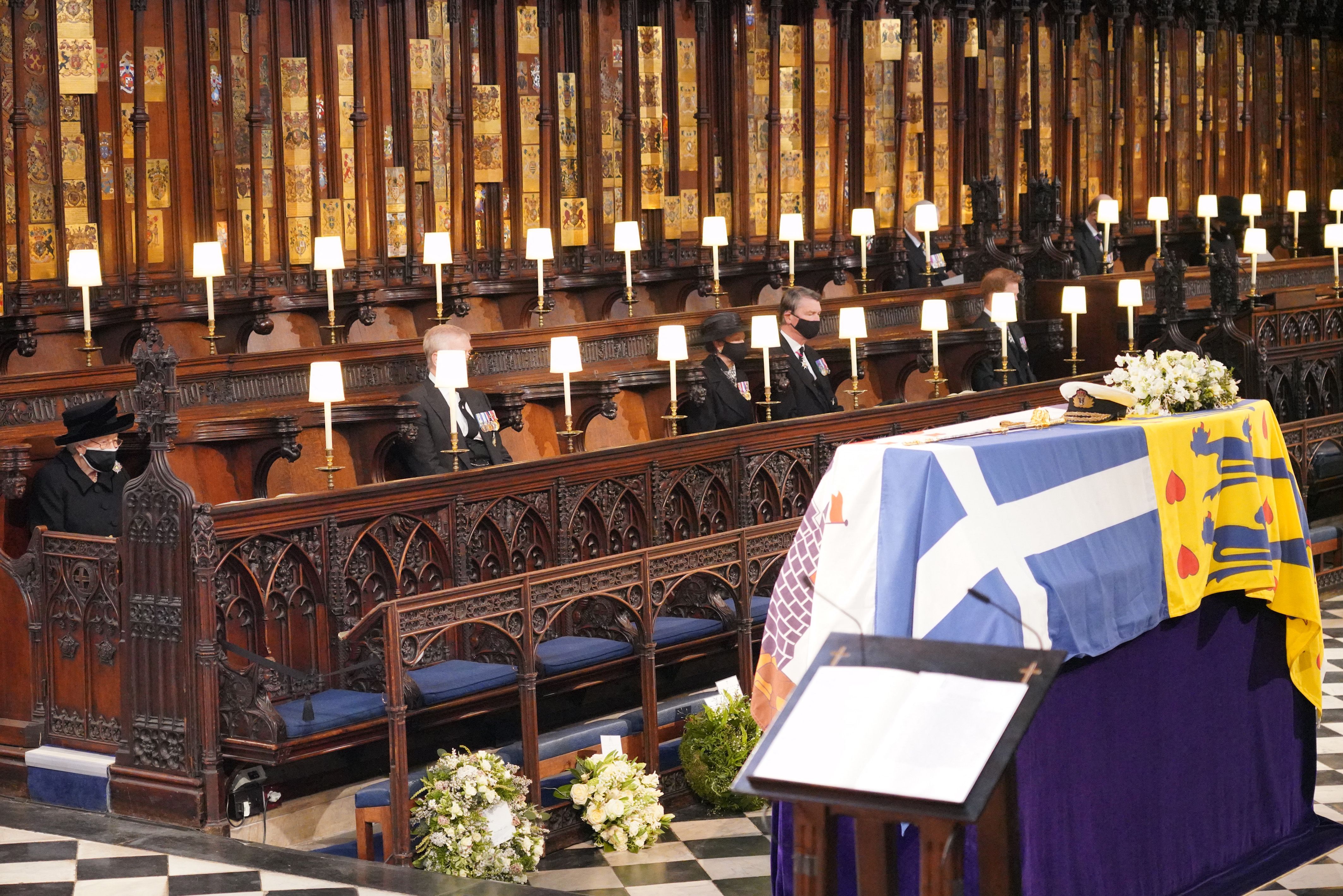 Queen Elizabeth II looks at the coffin of Britain's Prince Philip, Duke of Edinburgh during his funeral service at St George's Chapel in Windsor Castle on 17 April