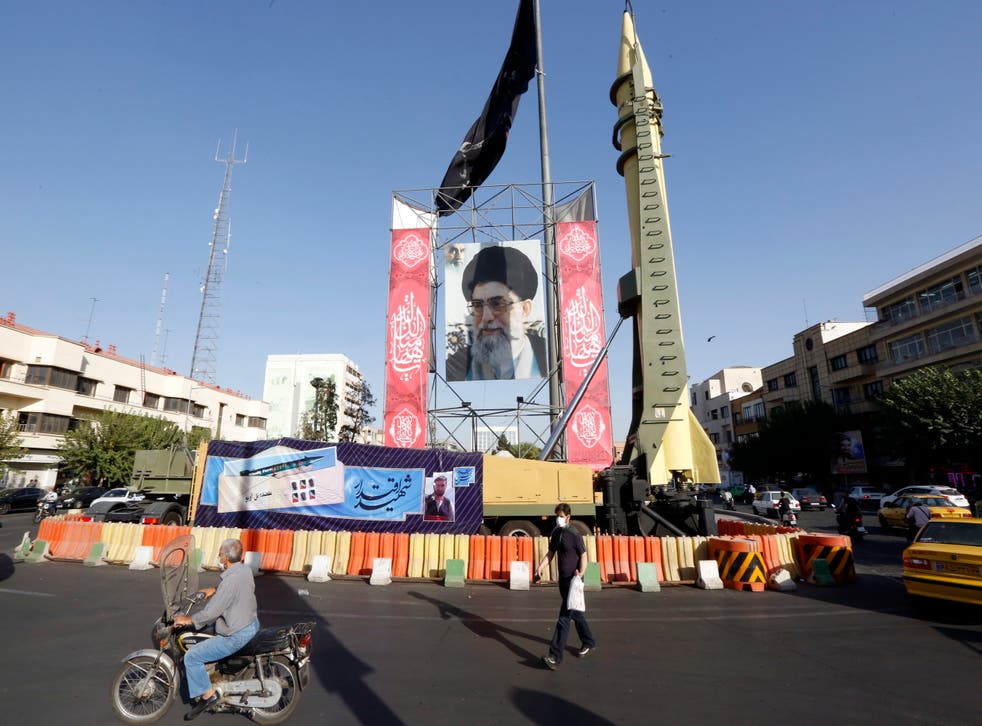 <p>A Shahab-3 surface-to-surface missile on display next to a picture of Iranian supreme leader Ayatollah Ali Khamenei</p>