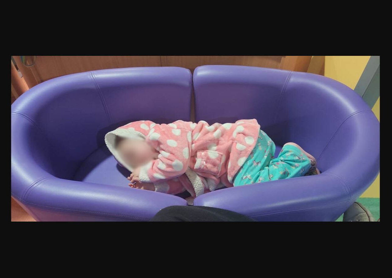 Violet Barker asleep on a makeshift bed at Royal Stoke Hospital last week
