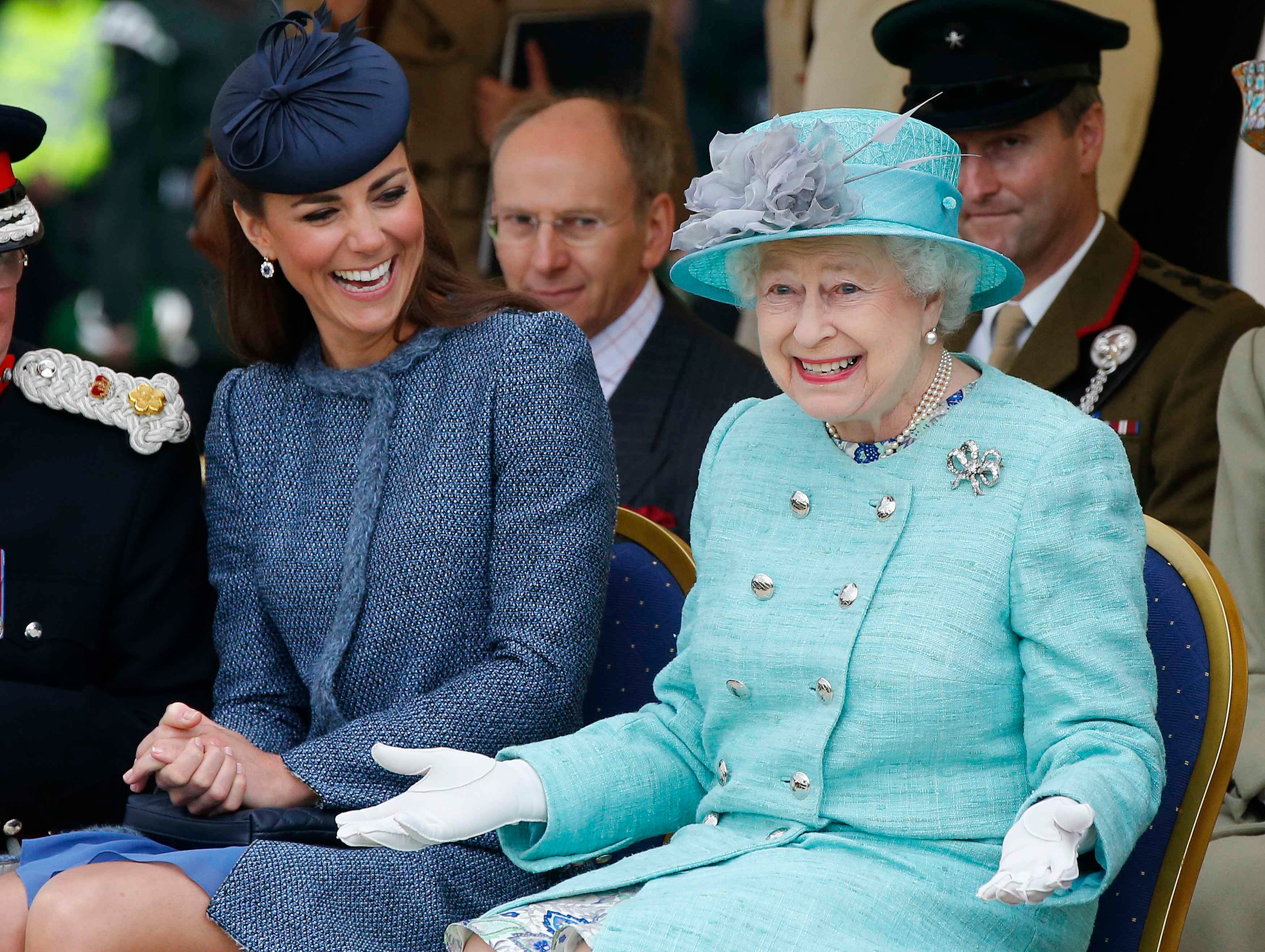 Catherine, Duchess of Cambridge laughs as Queen Elizabeth gestures during a visit to Vernon Park in Nottingham, 2012